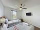 Comfortable bedroom with two twin beds, TV, ceiling fan, and natural light at 109 Pompano Beach Dr, Kissimmee, FL 34746