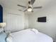 Comfortable bedroom with a queen bed, ceiling fan, TV, and double closet doors at 109 Pompano Beach Dr, Kissimmee, FL 34746