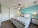 Cozy bedroom with a king-sized bed, ceiling fan, and neutral decor at 109 Pompano Beach Dr, Kissimmee, FL 34746