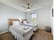 Cozy bedroom featuring two twin beds with striped linens, a ceiling fan, and a sunny window at 109 Pompano Beach Dr, Kissimmee, FL 34746