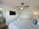 Inviting bedroom with a king-sized bed, ceiling fan, and ensuite bathroom access at 109 Pompano Beach Dr, Kissimmee, FL 34746