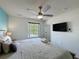 Bright bedroom with a ceiling fan, window view, and a king-sized bed at 109 Pompano Beach Dr, Kissimmee, FL 34746