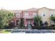 Charming townhouses featuring colorful facades, tile roofs, and lush landscaping in a vibrant community at 109 Pompano Beach Dr, Kissimmee, FL 34746