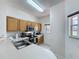 Efficient kitchen design with wood cabinets, stainless steel appliances, and a bright, windowed view at 109 Pompano Beach Dr, Kissimmee, FL 34746