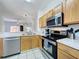 Modern kitchen with stainless steel appliances and sleek countertops, perfect for cooking and entertaining at 109 Pompano Beach Dr, Kissimmee, FL 34746