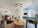 Open-concept living room with tile flooring, a ceiling fan, and a foosball table for entertainment at 109 Pompano Beach Dr, Kissimmee, FL 34746