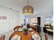 Open-concept living room with dining area, foosball table, and access to a patio at 109 Pompano Beach Dr, Kissimmee, FL 34746