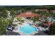 Stunning aerial view of community pool area and clubhouse offering luxurious amenities and relaxation at 109 Pompano Beach Dr, Kissimmee, FL 34746