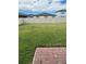 Spacious, fenced-in backyard featuring a well-maintained lawn and a brick-paved patio area for outdoor enjoyment at 1210 Zambrana Ct, Winter Haven, FL 33884