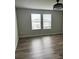 A bedroom with wood floors and large windows provides natural light at 1210 Zambrana Ct, Winter Haven, FL 33884