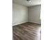 Wood-look flooring provides a neutral canvas for this sunny, empty bedroom at 1210 Zambrana Ct, Winter Haven, FL 33884