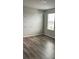 Bright bedroom with wood-look floors, a mobile and colorful rainbow wall decals at 1210 Zambrana Ct, Winter Haven, FL 33884