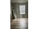 Spacious walk-in closet with wood-look flooring, shelving, and a bright window at 1210 Zambrana Ct, Winter Haven, FL 33884