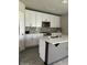 Modern kitchen with white cabinets, stainless steel appliances, and a center island at 1210 Zambrana Ct, Winter Haven, FL 33884