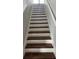 White staircase with wood treads at 1210 Zambrana Ct, Winter Haven, FL 33884