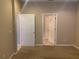 A bedroom with carpet floor provides access to other rooms through white paneled doors at 13620 Cepheus Dr, Orlando, FL 32828