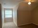 Bedroom with angled ceiling, carpet flooring and window at 13620 Cepheus Dr, Orlando, FL 32828