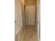 Hallway with neutral walls, tile flooring and several doors at 13620 Cepheus Dr, Orlando, FL 32828