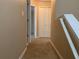 Hallway with carpet flooring, white trim, and doors to other rooms at 13620 Cepheus Dr, Orlando, FL 32828