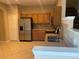 Functional kitchen with stainless steel appliances and warm-toned wooden cabinets at 13620 Cepheus Dr, Orlando, FL 32828