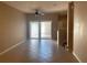 Bright living room with neutral walls, tile flooring, and sliding glass doors to the patio at 13620 Cepheus Dr, Orlando, FL 32828