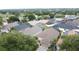 Aerial view of a well-kept neighborhood featuring mature trees and houses with lush lawns and varied roof colors at 1364 Rebecca Dr, Haines City, FL 33844