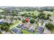 Aerial view showcases a residential area near a golf course, highlighted by mature trees and varied housing styles with a marker at 1364 Rebecca Dr, Haines City, FL 33844