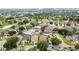Aerial view of a neighborhood with diverse houses, green lawns, and mature trees, plus a red location marker at 1364 Rebecca Dr, Haines City, FL 33844
