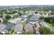 Aerial view of a neighborhood featuring houses with screened-in pools, surrounded by lush greenery and mature trees at 1364 Rebecca Dr, Haines City, FL 33844