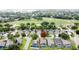A residential area near a lush green golf course, with diverse homes and a marker pinpointing a specific location at 1364 Rebecca Dr, Haines City, FL 33844