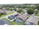 Aerial view of homes with screened-in pools in a lush neighborhood near a golf course at 1364 Rebecca Dr, Haines City, FL 33844