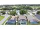 Aerial view of homes with screened-in pools in a leafy neighborhood near a golf course at 1364 Rebecca Dr, Haines City, FL 33844