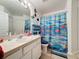 Colorful bathroom featuring a single sink vanity and a shower with curtain at 1364 Rebecca Dr, Haines City, FL 33844