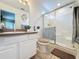 Cozy bathroom featuring a glass door shower, single sink vanity, and tiled floor at 1364 Rebecca Dr, Haines City, FL 33844