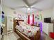 Bedroom featuring a wood-framed bed, ceiling fan, and ample natural light at 1364 Rebecca Dr, Haines City, FL 33844