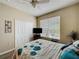 Comfortable bedroom features closet, window with blinds, and ceiling fan at 1364 Rebecca Dr, Haines City, FL 33844