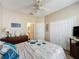 A comfortable bedroom features a closet, ceiling fan, and door to the bathroom at 1364 Rebecca Dr, Haines City, FL 33844