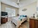 A cozy bedroom features a window with blinds, a ceiling fan, and a television at 1364 Rebecca Dr, Haines City, FL 33844