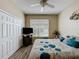 A cozy bedroom features a window with blinds, a ceiling fan, and a television at 1364 Rebecca Dr, Haines City, FL 33844