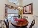 Dining area with decorative light fixture, large window, and view of the pool at 1364 Rebecca Dr, Haines City, FL 33844