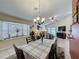 Dining room with large bay window, chandelier, and views of the living room at 1364 Rebecca Dr, Haines City, FL 33844