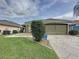 Charming single-story home with a well-manicured lawn and inviting two-car garage at 1364 Rebecca Dr, Haines City, FL 33844