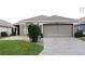 Charming single-story home with a well-manicured lawn and inviting two-car garage at 1364 Rebecca Dr, Haines City, FL 33844