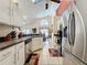 Open-concept kitchen features stainless steel appliances, and a view of the dining and living areas at 1364 Rebecca Dr, Haines City, FL 33844