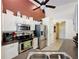 Well-equipped kitchen with stainless steel appliances, white cabinetry, and eat-in counter at 1364 Rebecca Dr, Haines City, FL 33844