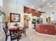Open-concept kitchen and dining area with stainless steel appliances and tile flooring at 1364 Rebecca Dr, Haines City, FL 33844