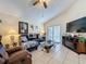 Comfortable living room featuring tile floors, vaulted ceiling, and sliding glass door to outdoor space at 1364 Rebecca Dr, Haines City, FL 33844