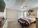 A comfortable main bedroom featuring wood flooring, a ceiling fan, and access to an outdoor pool at 1364 Rebecca Dr, Haines City, FL 33844