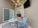 Covered patio with a ceiling fan, outdoor seating, and a mounted TV, creating a perfect space for relaxation at 1364 Rebecca Dr, Haines City, FL 33844