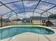 Private backyard pool with screened enclosure and ample deck space for outdoor entertaining at 1364 Rebecca Dr, Haines City, FL 33844